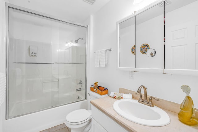 bathroom featuring toilet, shower / bath combination with glass door, visible vents, and vanity