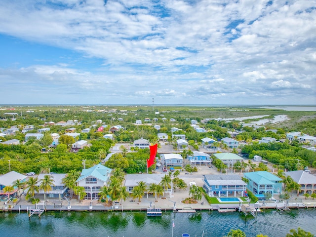 drone / aerial view featuring a water view and a residential view