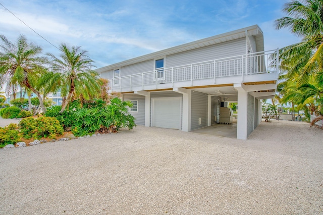 view of front of property with a carport, driveway, and an attached garage