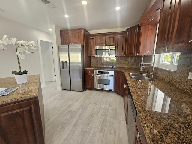 392 Laguna Ave, Key Largo, FL 33037 - kitchen featuring appliances with stainless steel finishes, a sink, tasteful backsplash, light wood-type flooring, and recessed lighting