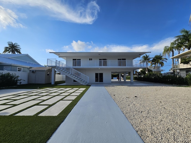 392 Laguna Ave, Key Largo, FL 33037 - back of house featuring a carport, stairs, and driveway