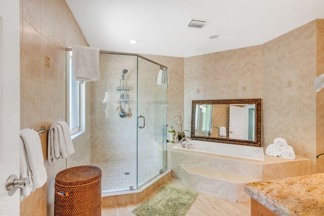 bathroom with vanity and separate shower and tub