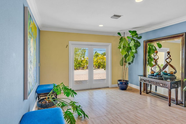 entryway with light tile patterned floors, crown molding, and french doors