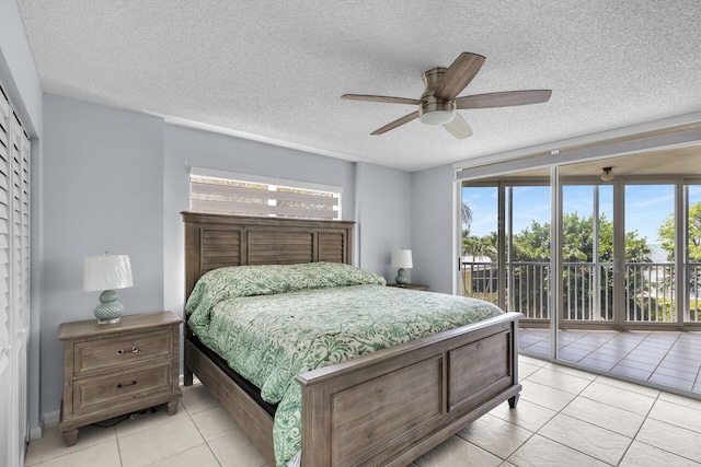 87851 Old Hwy Unit K26, Islamorada, FL 33036 - bedroom with access to outside, light tile patterned floors, a textured ceiling, multiple windows, and ceiling fan