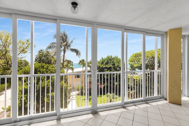 87851 Old Hwy Unit K26, Islamorada, FL 33036 - unfurnished sunroom with tile patterned floors and a water view