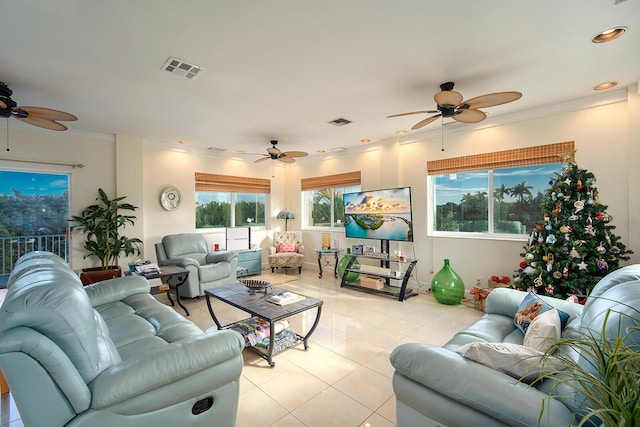 living room featuring light tile patterned floors, ornamental molding, and visible vents