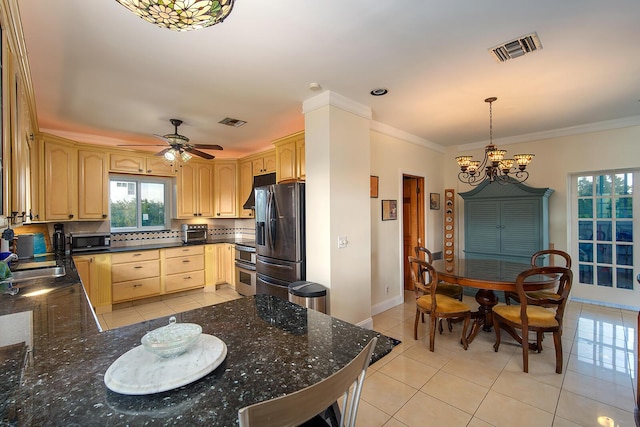 kitchen with appliances with stainless steel finishes, light brown cabinets, visible vents, and decorative light fixtures