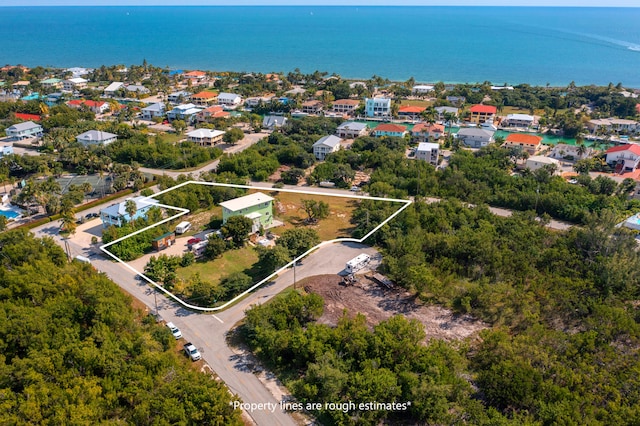 drone / aerial view with a water view and a residential view