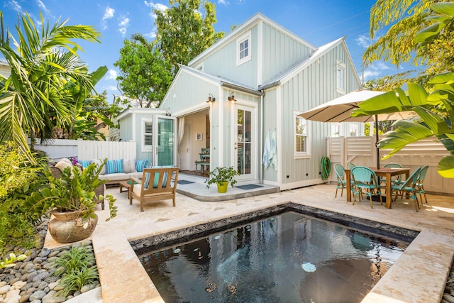 rear view of house featuring a patio area and outdoor lounge area