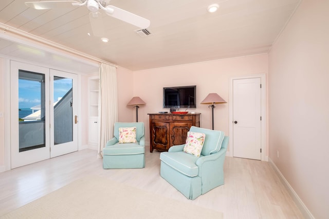 living area featuring light hardwood / wood-style flooring, french doors, and ceiling fan