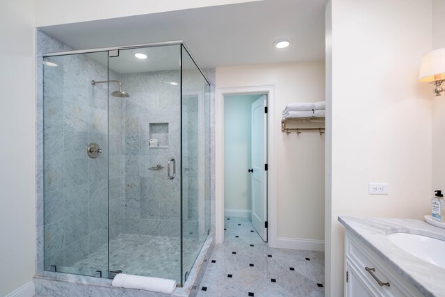 bathroom with vanity and a shower with shower door