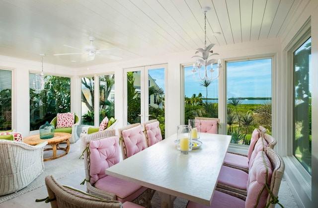 sunroom / solarium featuring ceiling fan, a wealth of natural light, and wood ceiling