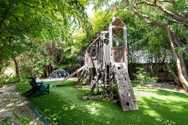 view of playground with a lawn