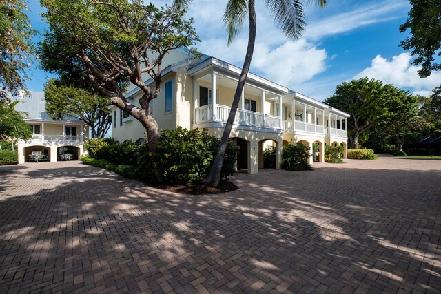 view of front facade featuring a carport and a balcony