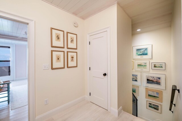 hallway with wood ceiling and light hardwood / wood-style floors