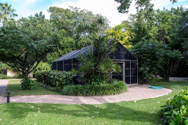 view of outbuilding featuring a lawn