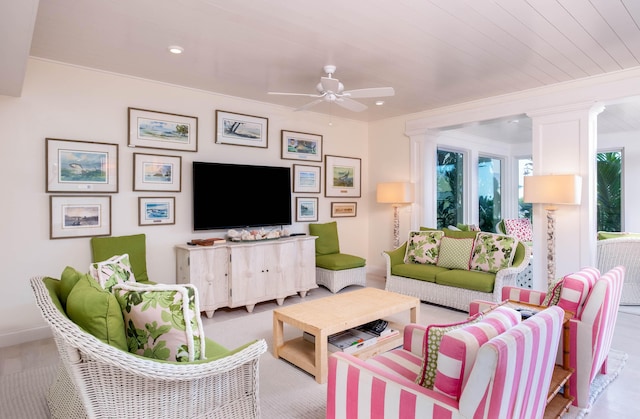 living room featuring crown molding, a wealth of natural light, and ceiling fan