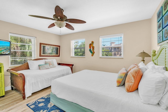 bedroom with light hardwood / wood-style floors and ceiling fan