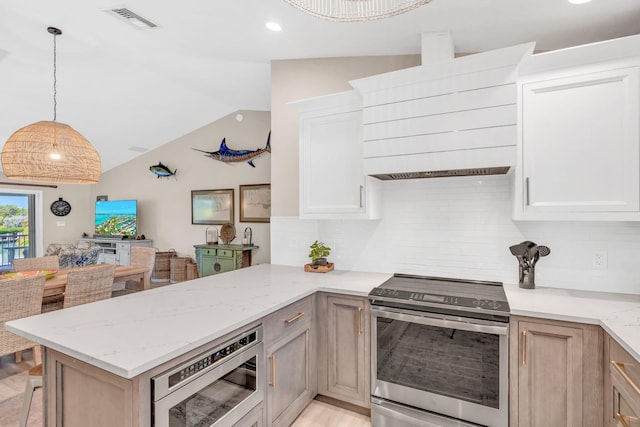 kitchen featuring light brown cabinetry, light stone counters, stainless steel appliances, and kitchen peninsula