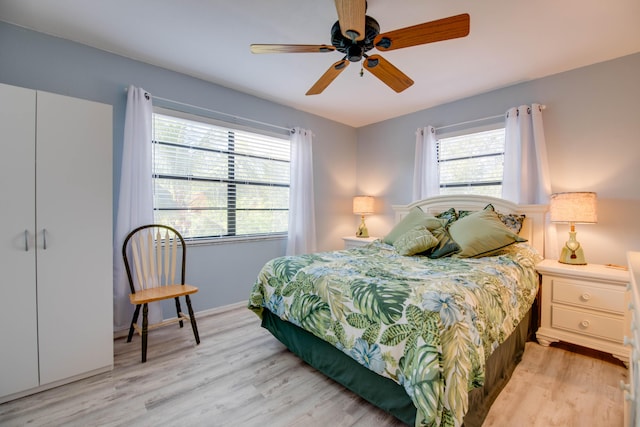 bedroom with ceiling fan and light wood-type flooring