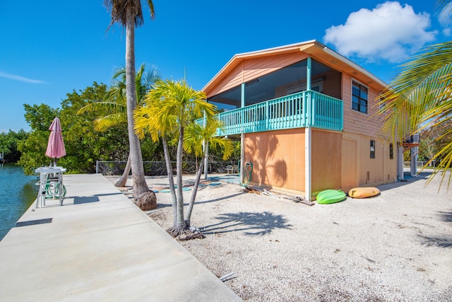 view of property exterior with a patio area and a balcony