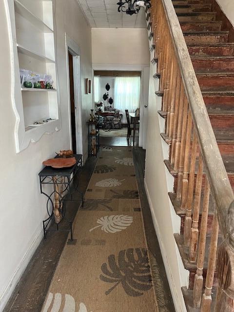 hall with stairway and baseboards