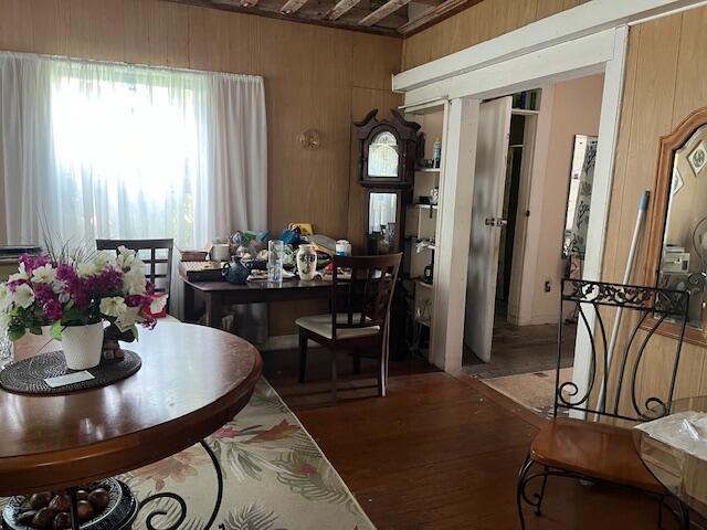 dining room featuring wood walls and wood finished floors