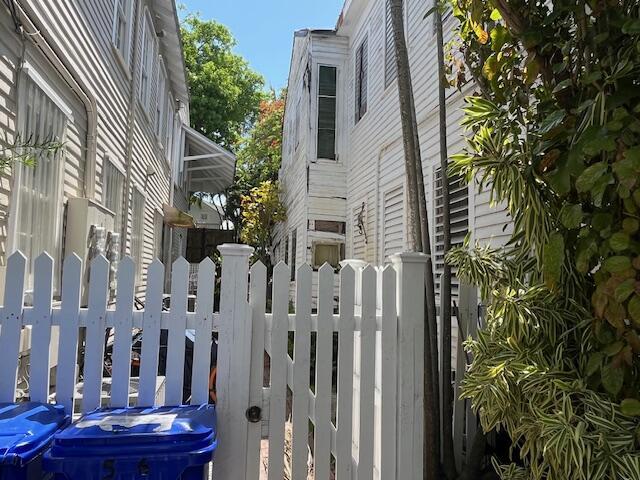 view of side of property featuring fence and a gate