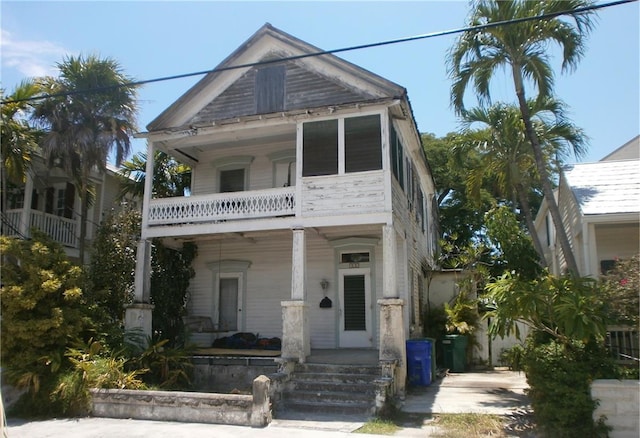 view of front of property with a porch and a balcony