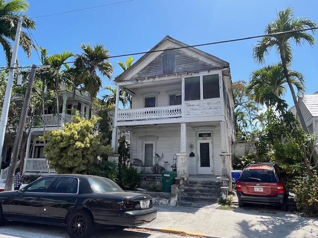 view of front of property with a balcony and covered porch