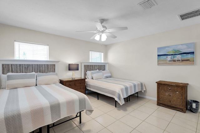 bedroom with ceiling fan and light tile patterned floors