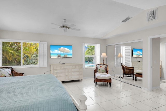 bedroom featuring vaulted ceiling, light tile patterned floors, and ceiling fan