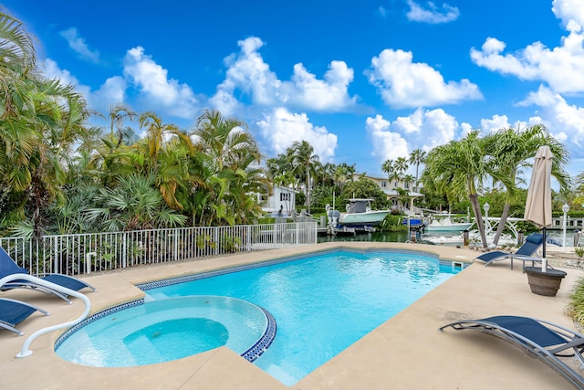 view of pool with a patio area and an in ground hot tub