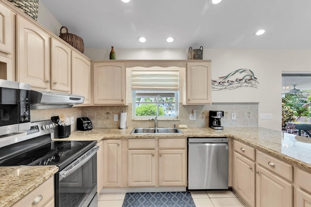 kitchen featuring appliances with stainless steel finishes, sink, and light brown cabinets