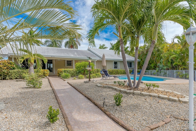 view of front of house featuring a fenced in pool and a patio area