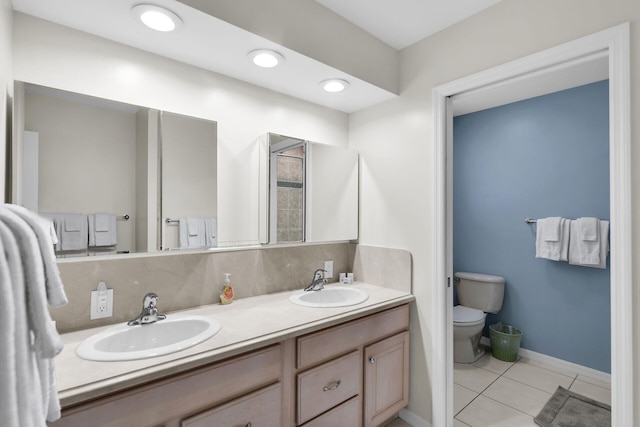 bathroom with tile patterned floors, vanity, and toilet