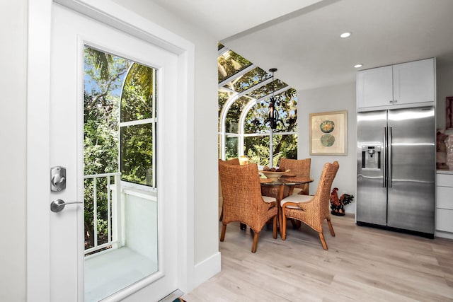 dining space with light hardwood / wood-style floors