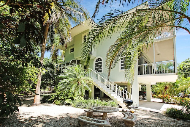 rear view of property with a sunroom