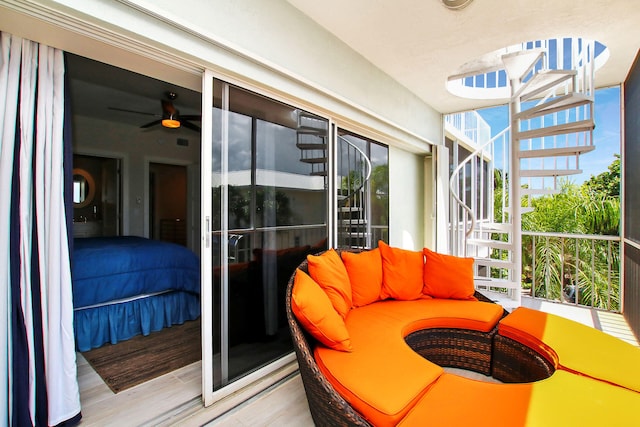 sunroom / solarium featuring ceiling fan