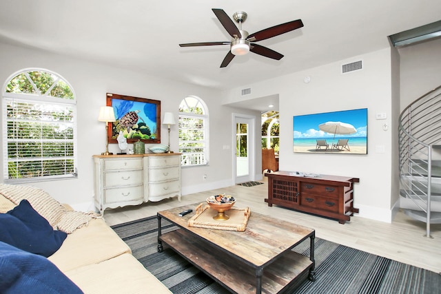 living room featuring light hardwood / wood-style floors and ceiling fan