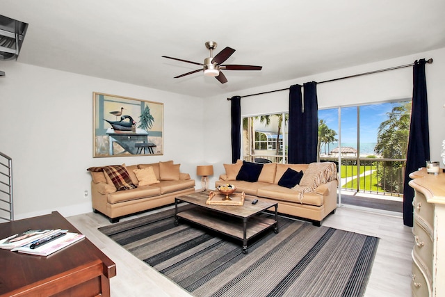 living room featuring ceiling fan and light wood-type flooring