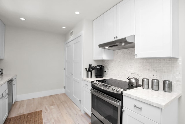 kitchen with white cabinetry, decorative backsplash, stainless steel appliances, and light wood-type flooring