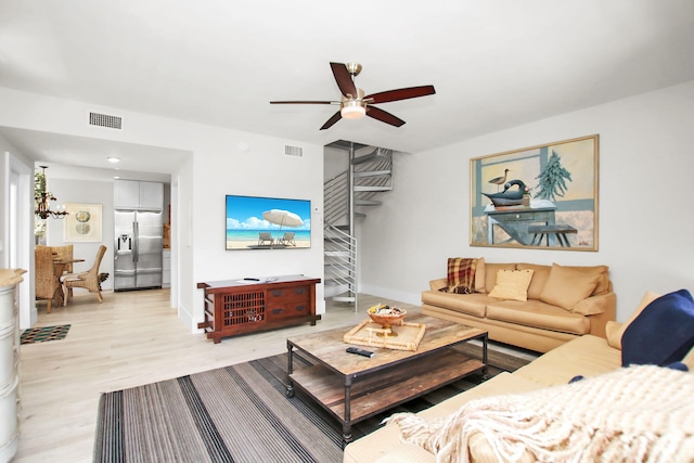 living room with ceiling fan and light hardwood / wood-style floors