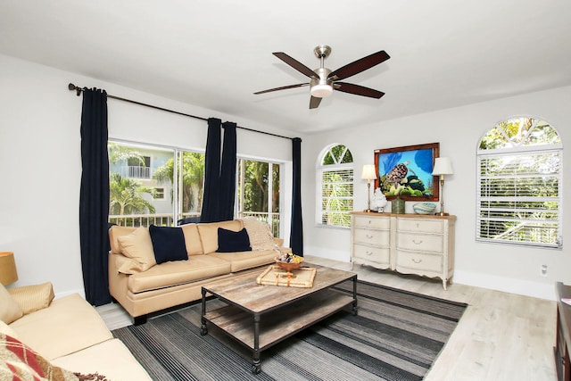 living room with light hardwood / wood-style flooring and ceiling fan