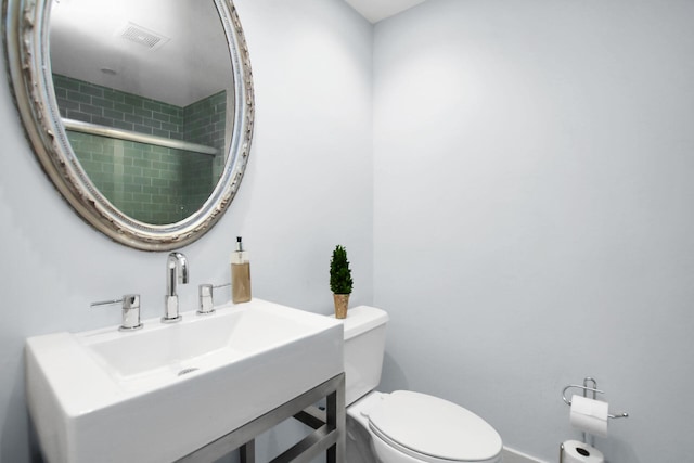 bathroom featuring sink and toilet