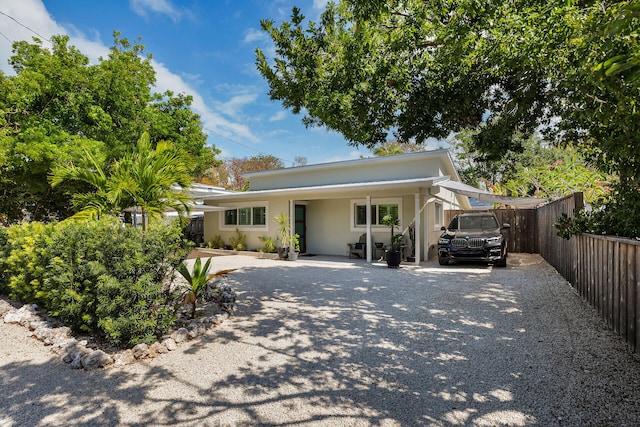 122 S Bay Harbor Dr, Key Largo, FL 33037 - view of front of house with driveway, fence, and stucco siding