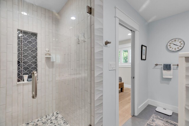 122 S Bay Harbor Dr, Key Largo, FL 33037 - bathroom featuring a tile shower, tile patterned flooring, and baseboards