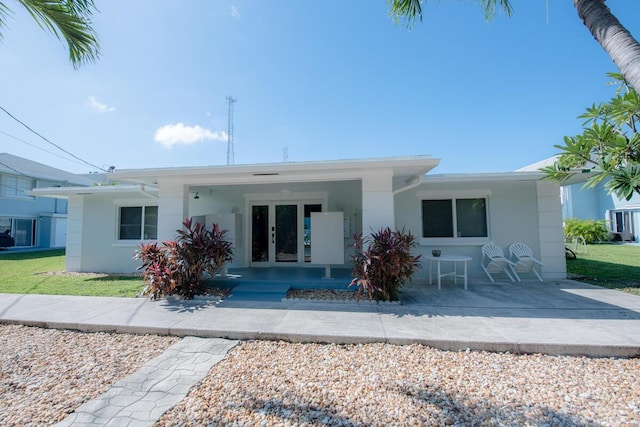 rear view of property with french doors