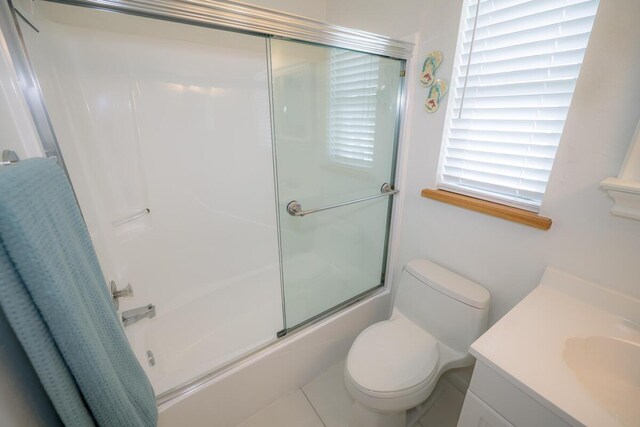 full bathroom with bath / shower combo with glass door, vanity, and toilet