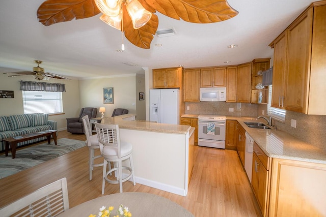 kitchen with sink, white appliances, ceiling fan, tasteful backsplash, and light hardwood / wood-style floors